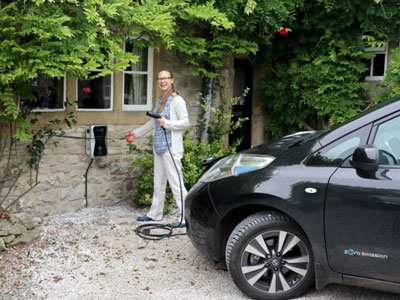 Faith Johnson plugging in her electric car